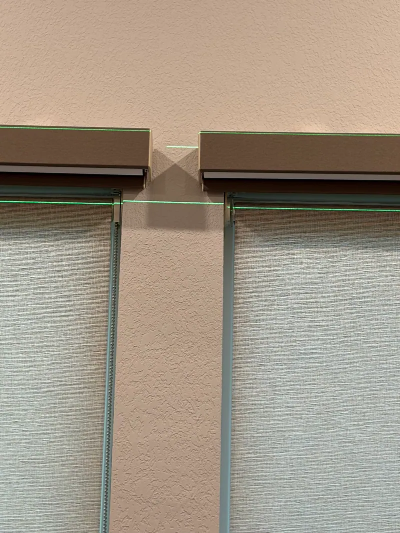 Blackout and light-filtering roller shades shown at a bedroom window.
