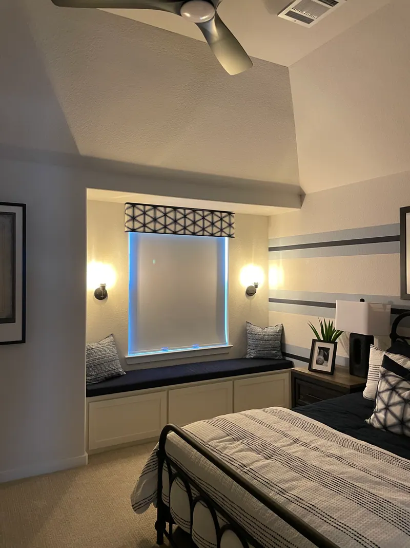 Blackout roller shade covering another bedroom window.