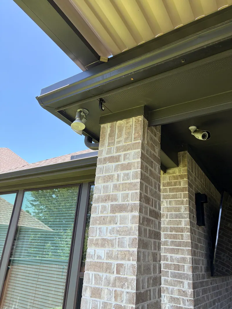 Close-up of retractable awning hardware and striped fabric.