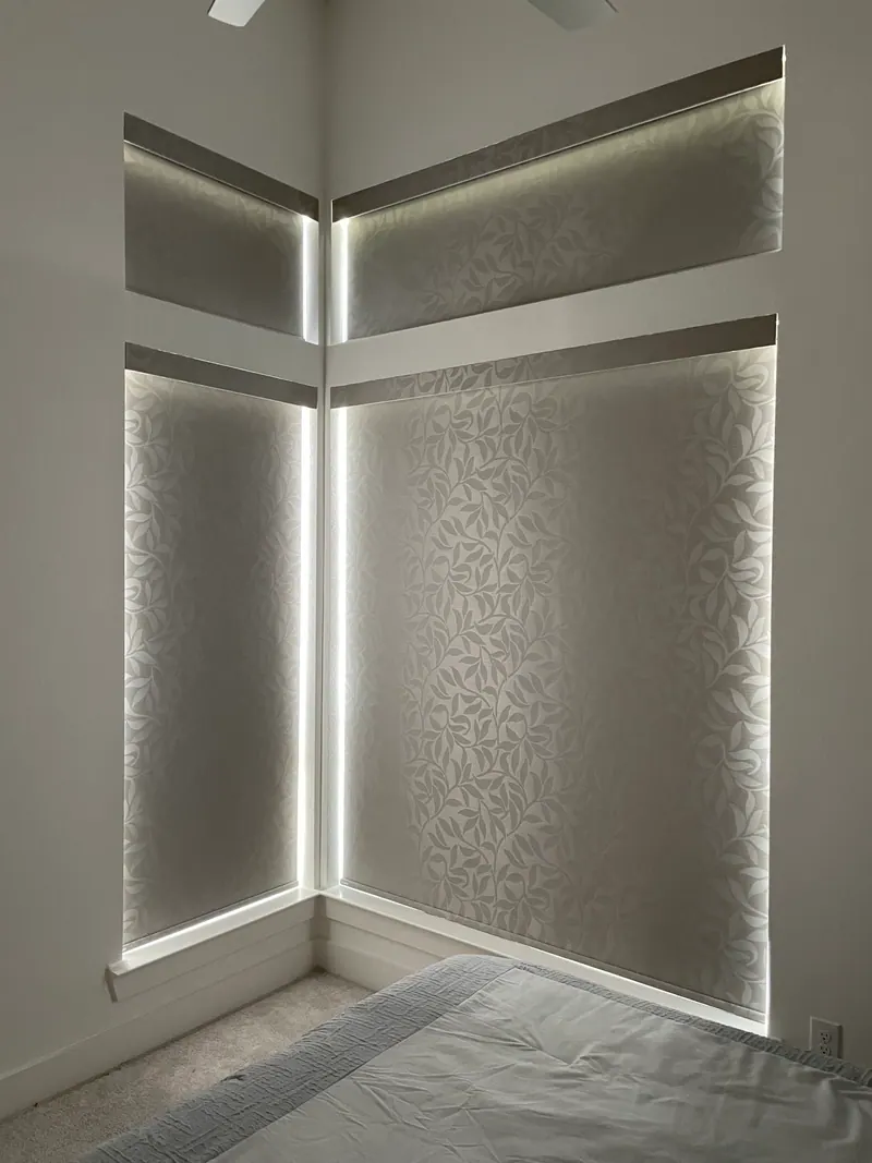 Patterned blackout roller shade lowered over an office window.