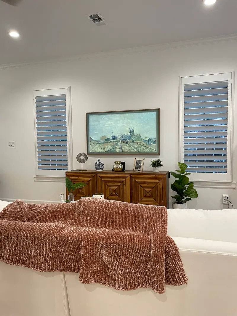 White plantation shutters on a living-room window.