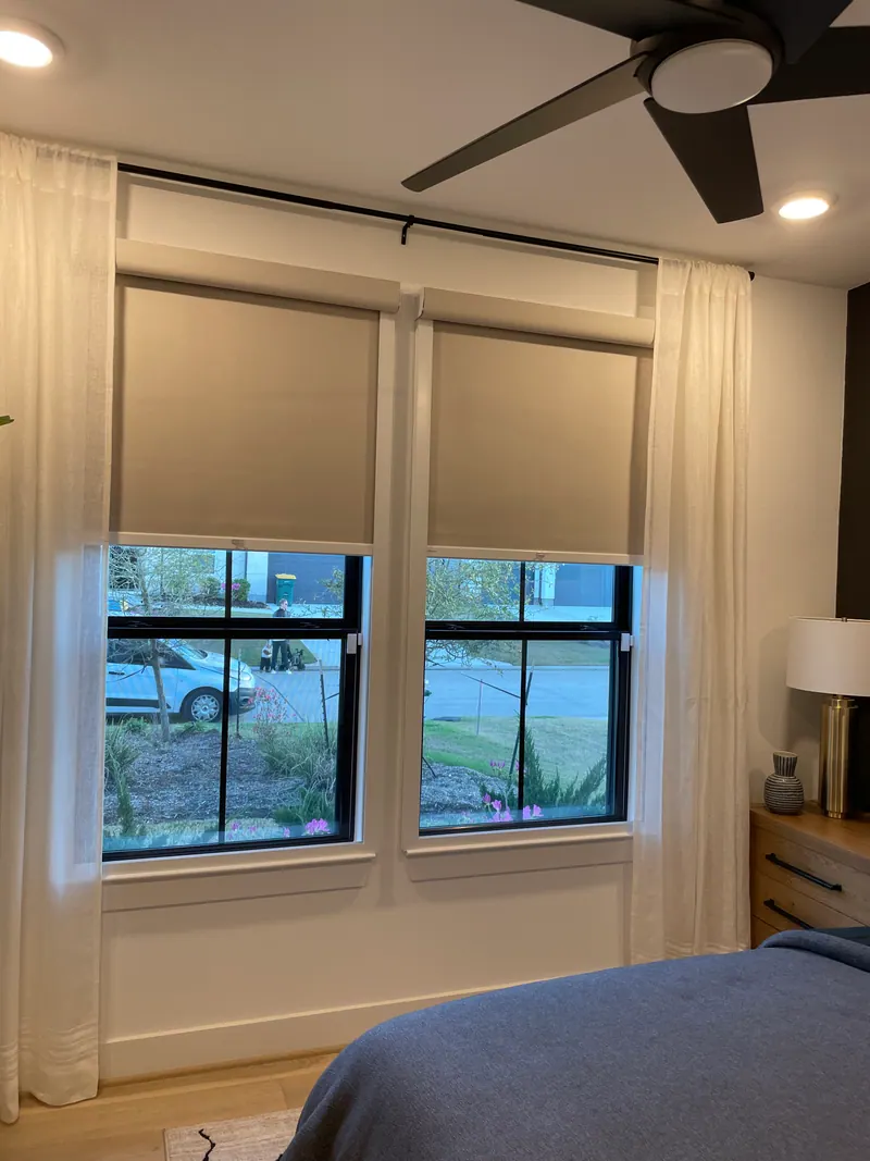Roller shade covering a front-bedroom window.