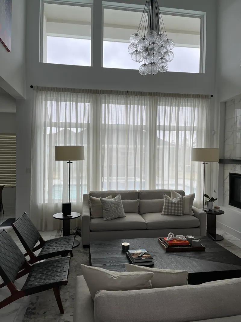 Sheer curtains hanging across a living-room window.